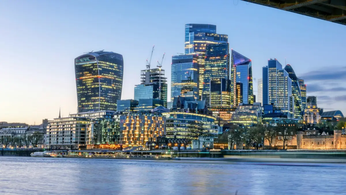 The City of London skyline at dusk across the River Thames